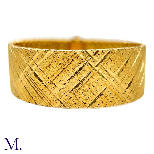 37 - A Gold Woven Bracelet by Georges Lenfant.

The 18ct yellow gold bracelet in woven and striated patte... 