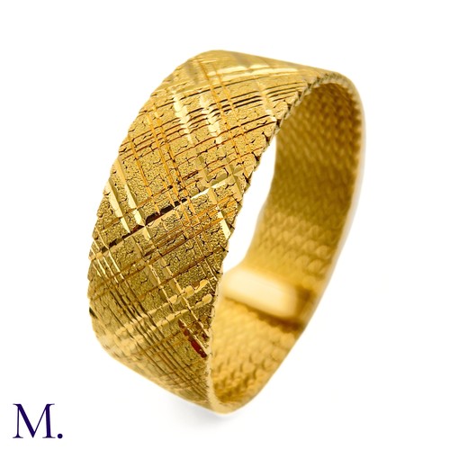 37 - A Gold Woven Bracelet by Georges Lenfant.

The 18ct yellow gold bracelet in woven and striated patte... 