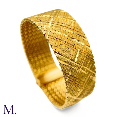 37 - A Gold Woven Bracelet by Georges Lenfant.

The 18ct yellow gold bracelet in woven and striated patte... 