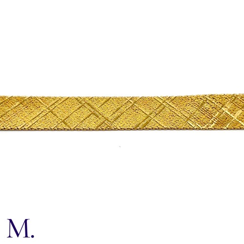 37 - A Gold Woven Bracelet by Georges Lenfant.

The 18ct yellow gold bracelet in woven and striated patte... 