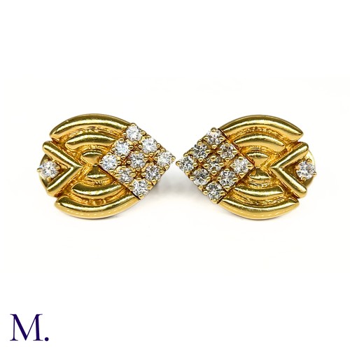 1 - A Pair of Diamond-Set Earclips by Mellerio

The 18ct yellow gold earclips are each set with 10 round... 