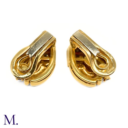 1 - A Pair of Diamond-Set Earclips by Mellerio

The 18ct yellow gold earclips are each set with 10 round... 