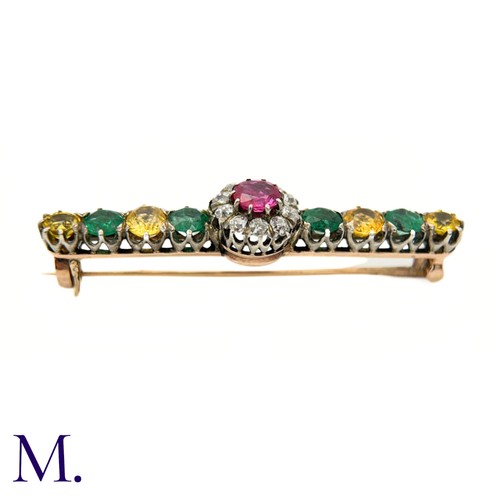 15 - An Antique Diamond, Ruby, Emerald and Yellow Sapphire Brooch.

The brooch is set with a ruby (untest... 