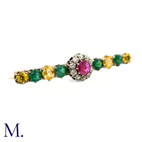 15 - An Antique Diamond, Ruby, Emerald and Yellow Sapphire Brooch.

The brooch is set with a ruby (untest... 