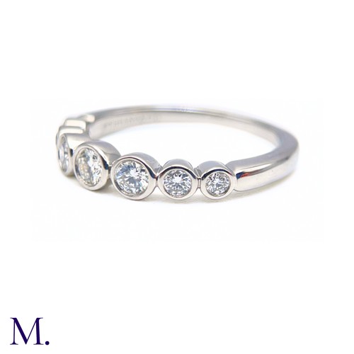 16 - A Platinum and Diamond Jazz Ring by Tiffany & Co.

The platinum band is set with seven round cut dia... 