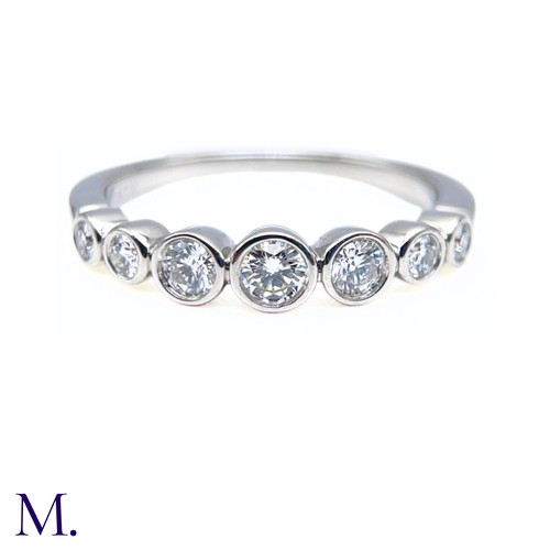 16 - A Platinum and Diamond Jazz Ring by Tiffany & Co.

The platinum band is set with seven round cut dia... 