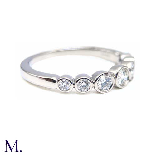 16 - A Platinum and Diamond Jazz Ring by Tiffany & Co.

The platinum band is set with seven round cut dia... 