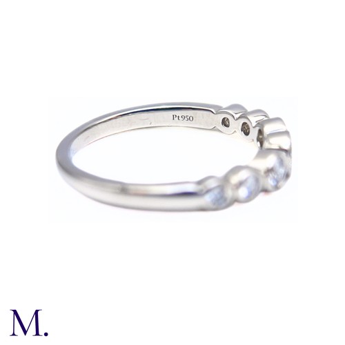 16 - A Platinum and Diamond Jazz Ring by Tiffany & Co.

The platinum band is set with seven round cut dia... 