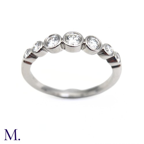 16 - A Platinum and Diamond Jazz Ring by Tiffany & Co.

The platinum band is set with seven round cut dia... 