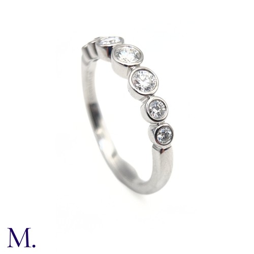 16 - A Platinum and Diamond Jazz Ring by Tiffany & Co.

The platinum band is set with seven round cut dia... 