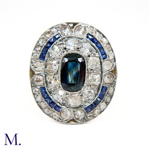 19 - A Sapphire and Diamond Cluster Ring

The 18ct gold ring is has a flat panel face set with an elongat... 