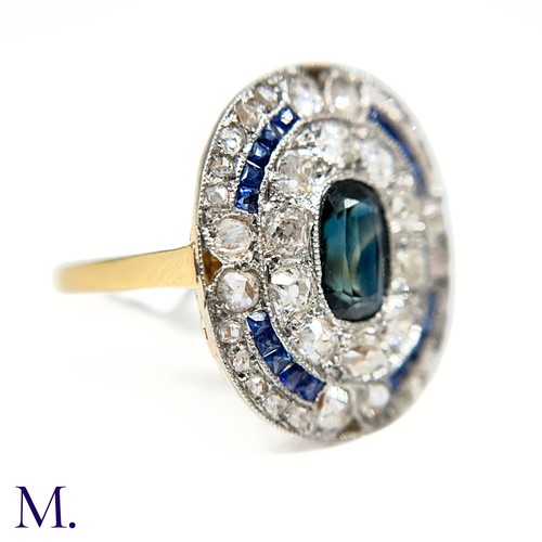 19 - A Sapphire and Diamond Cluster Ring

The 18ct gold ring is has a flat panel face set with an elongat... 