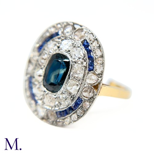 19 - A Sapphire and Diamond Cluster Ring

The 18ct gold ring is has a flat panel face set with an elongat... 