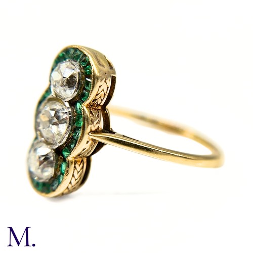 20 - A Calibre Emerald and Diamond Ring

The 18ct yellow gold ring is set with three principal old cut di... 