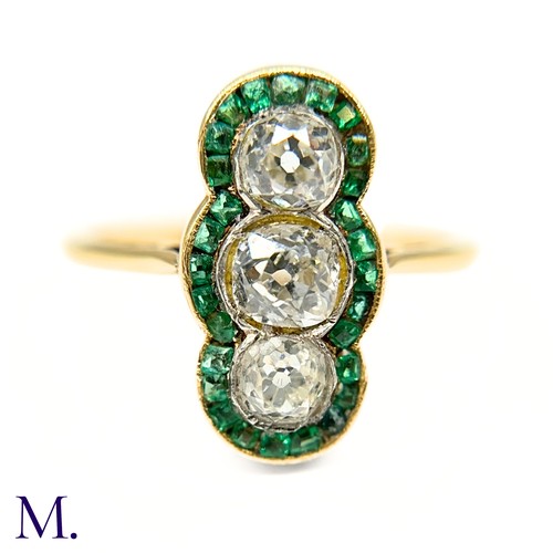 20 - A Calibre Emerald and Diamond Ring

The 18ct yellow gold ring is set with three principal old cut di... 