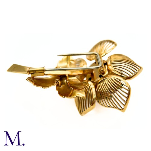 22 - A Fine Ruby, Diamond and Emerald Articulated Flower Brooch.

The 18ct yellow gold flower brooch is s... 