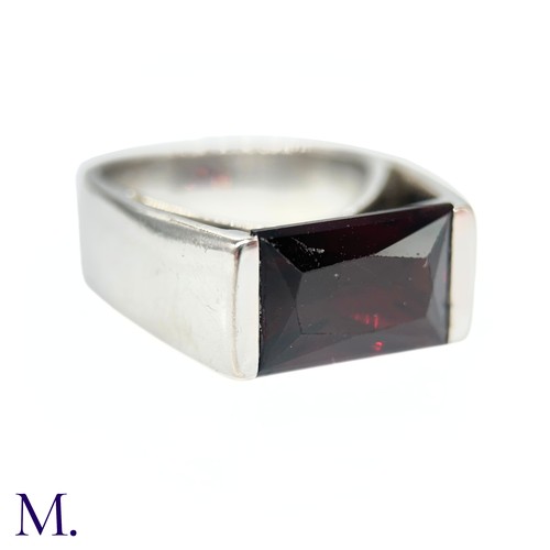 27 - A Garnet Ring by Poiray

The 18ct white gold ring by Parisian jeweller, Poiray, is set with a rectan... 