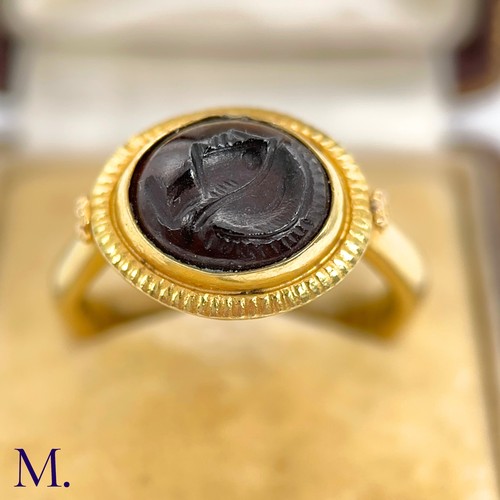 36 - An Antique Intaglio Signet Ring

The antique signet ring is set with a carved garnet intaglio stone ... 