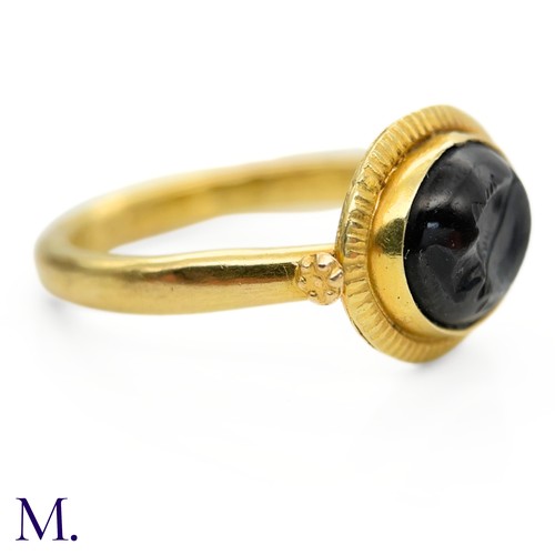 36 - An Antique Intaglio Signet Ring

The antique signet ring is set with a carved garnet intaglio stone ... 