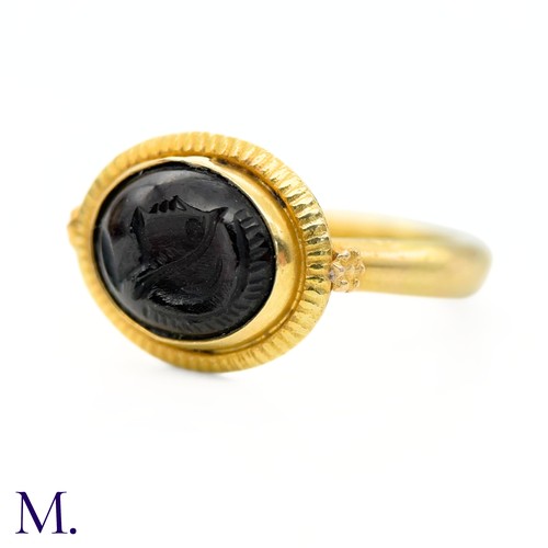 36 - An Antique Intaglio Signet Ring

The antique signet ring is set with a carved garnet intaglio stone ... 