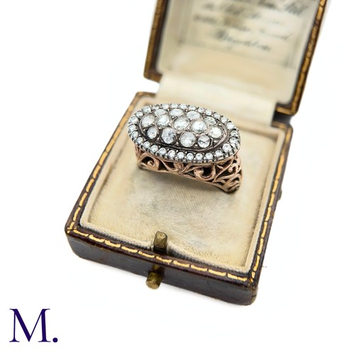 37 - An Antique Diamond Cluster Open-Work Ring.

The antique ring has a closed-back oval face set with th... 