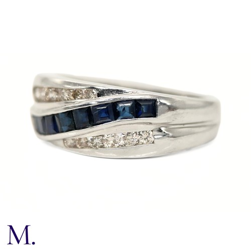 39 - The 14ct white gold ring is set with calibrated sapphires and approximately 0.18ct of diamonds in a ... 