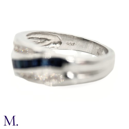 39 - The 14ct white gold ring is set with calibrated sapphires and approximately 0.18ct of diamonds in a ... 