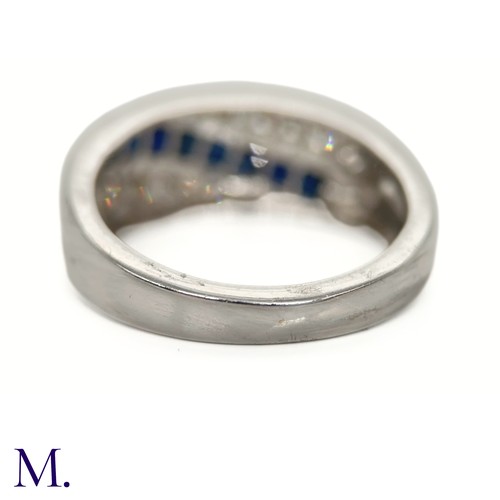 39 - The 14ct white gold ring is set with calibrated sapphires and approximately 0.18ct of diamonds in a ... 