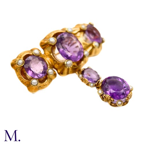 47 - An Antique Amethyst and Pearl Drop Brooch

The large antique 18ct gold brooch is set with five ameth... 