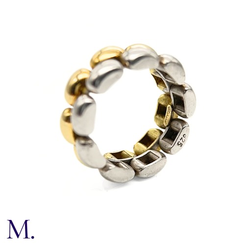 55 - A Gold and Silver Ring by Chopard

The 18ct yellow gold and silver ring is by Chopard.  The band is ... 