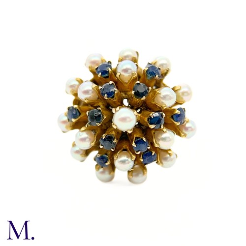 67 - A Pearl and Sapphire Cluster Ring 

The modernist 14ct yellow gold ring is set with pearls and sapph... 