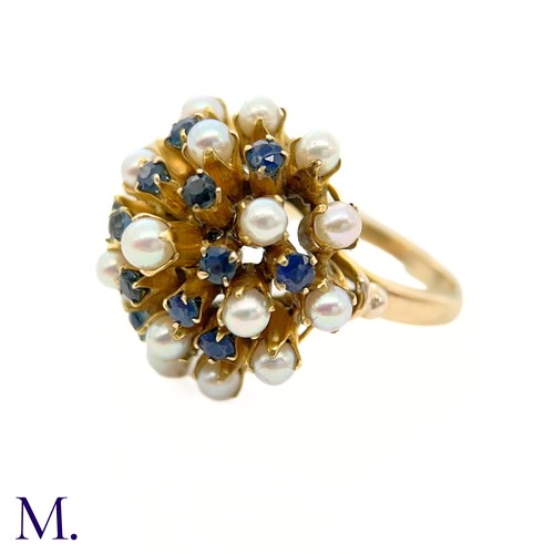 67 - A Pearl and Sapphire Cluster Ring 

The modernist 14ct yellow gold ring is set with pearls and sapph... 