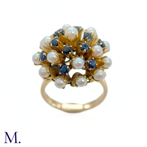 67 - A Pearl and Sapphire Cluster Ring 

The modernist 14ct yellow gold ring is set with pearls and sapph... 