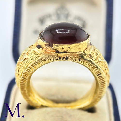 73 - An Antique Garnet Signet Ring

The exceptional ring is crafted from high carat gold with engravings ... 