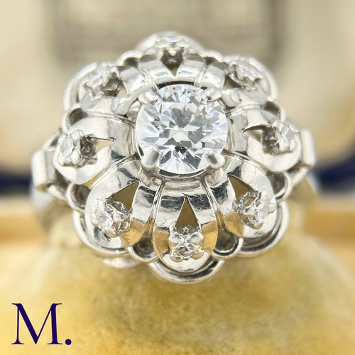 54 - A French Diamond Cluster Ring

The French ring is set with a round cut diamond to the centre of appr... 