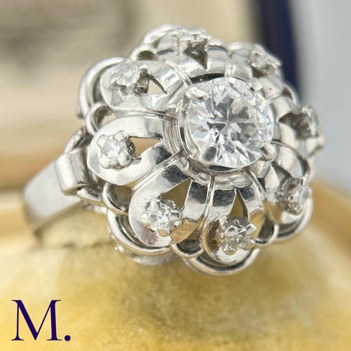 54 - A French Diamond Cluster Ring

The French ring is set with a round cut diamond to the centre of appr... 