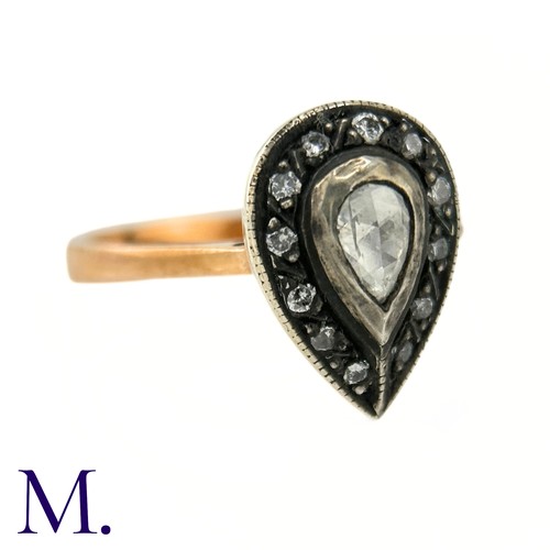 47 - An Antique Rose Diamond Ring

The rose gold band tapers into a pear-shaped setting in silver which i... 