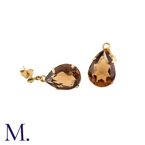 22 - A Pair of Gemstone Earrings

The 9ct yellow gold earrings are set with a burnt orange-brown pear-sha... 