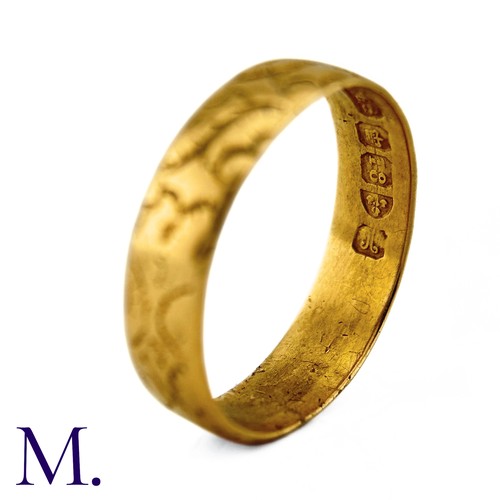 35 - A Carved 18ct Gold Band

The 18ct yellow gold band is engraved with recurrent patterns.

Weight: 4.3... 