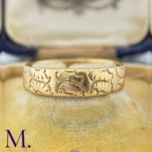 35 - A Carved 18ct Gold Band

The 18ct yellow gold band is engraved with recurrent patterns.

Weight: 4.3... 