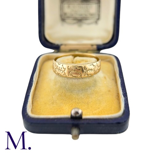 35 - A Carved 18ct Gold Band

The 18ct yellow gold band is engraved with recurrent patterns.

Weight: 4.3... 