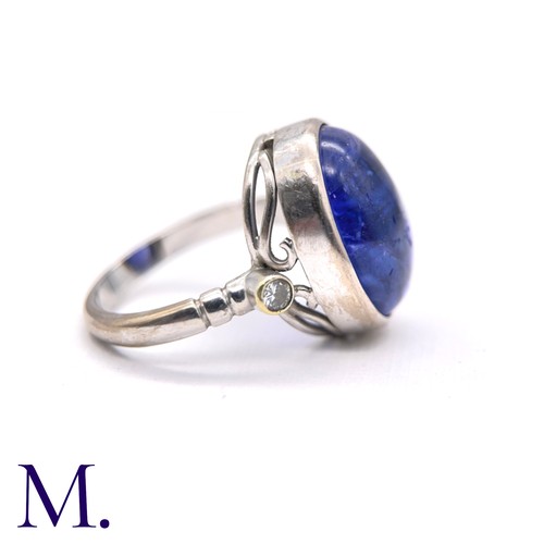 108 - A Cabochon Tanzanite and Diamond Ring

The 18ct white gold ring is set with a large cabochon tanzani... 