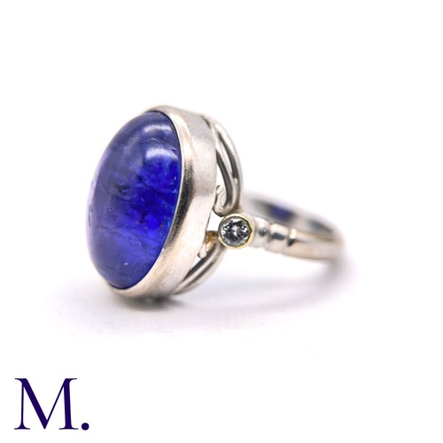 108 - A Cabochon Tanzanite and Diamond Ring

The 18ct white gold ring is set with a large cabochon tanzani... 