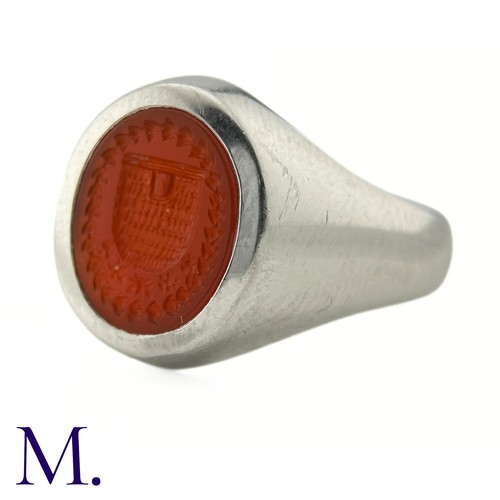 58 - A Platinum and Carnelian Signet Ring

The platinum ring is set with a carved oval-shaped carnelian d... 