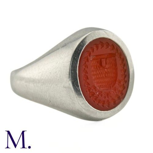 58 - A Platinum and Carnelian Signet Ring

The platinum ring is set with a carved oval-shaped carnelian d... 