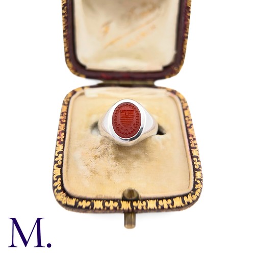 58 - A Platinum and Carnelian Signet Ring

The platinum ring is set with a carved oval-shaped carnelian d... 