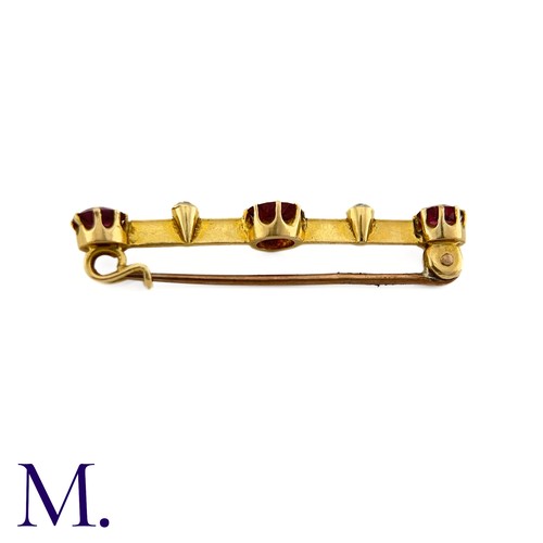 87 - An Antique Garnet and Diamond Bar Brooch

This 9ct yellow gold brooch is set with three deep purple-... 