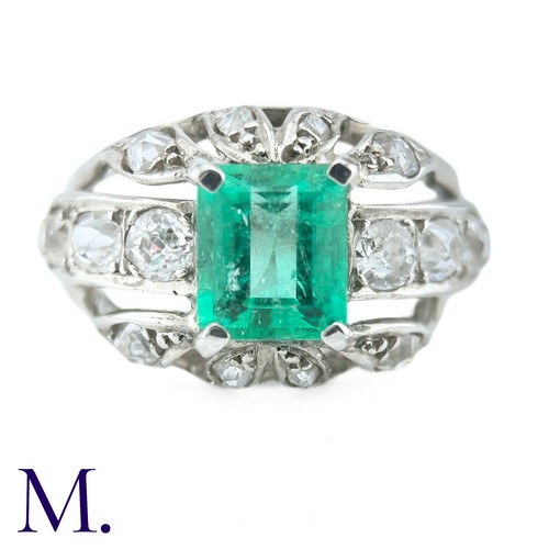 60 - An Emerald and Diamond Ring
The 18ct white gold ring is set with a bright green emerald cut emerald ... 