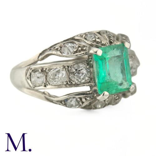 60 - An Emerald and Diamond Ring
The 18ct white gold ring is set with a bright green emerald cut emerald ... 