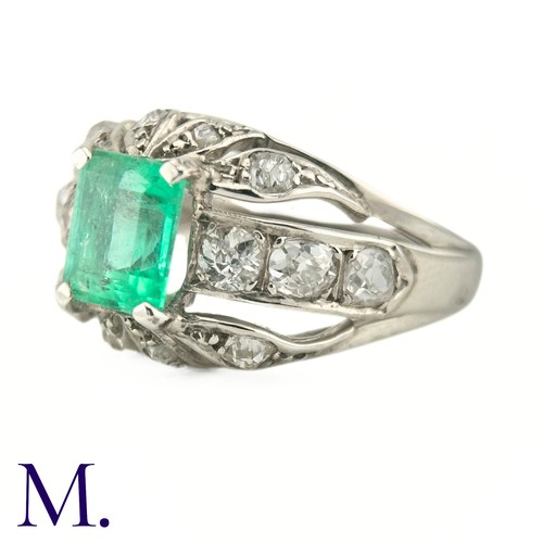 60 - An Emerald and Diamond Ring
The 18ct white gold ring is set with a bright green emerald cut emerald ... 